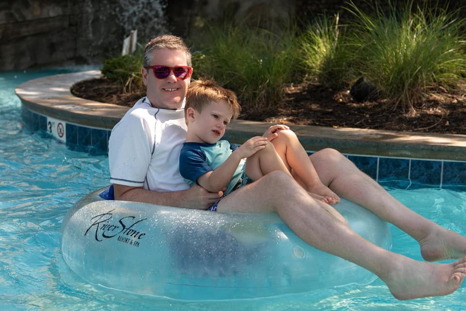 A dad and his son float down a lazy river at River Stone Resort in Pigeon Forge.