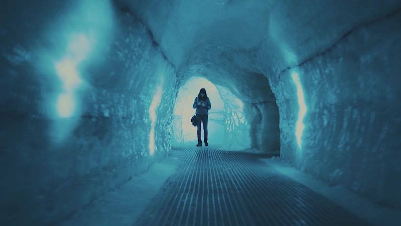 A person walks through an ice tunnel at the Perlan Museum.