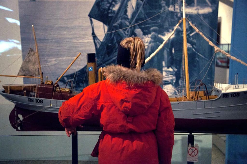 A young girl looks at a ship display in the Reykjavik Maritime Museum.