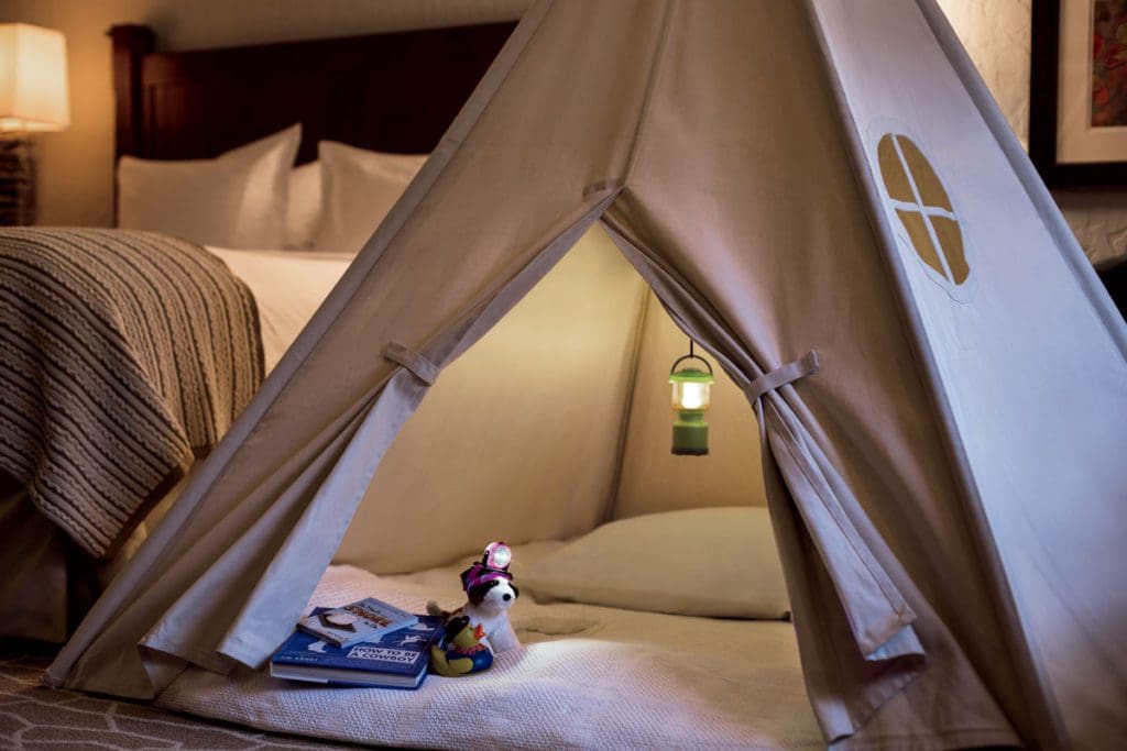 A small in-room tent, available for kids who stay at the The Ritz-Carlton, Bachelor Gulch. Inside the tent is a stuffed animal, books, and soft lamp lighting.