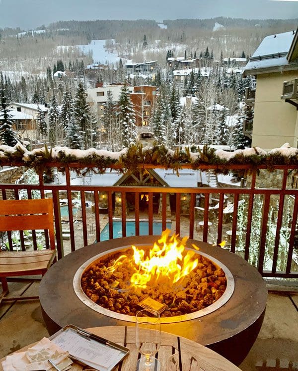 A fire pit on a balcony overlooking the grounds at the Four Seasons in Vail.