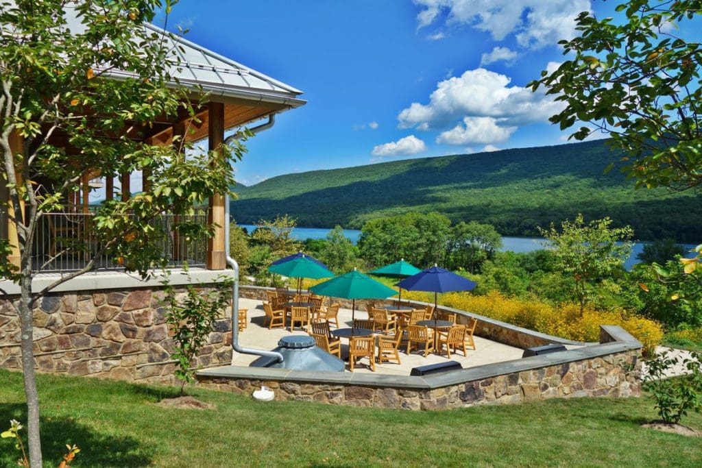 The outdoor patio area of the The Nature Inn at Bald Eagle, surrounded by scenic woods.