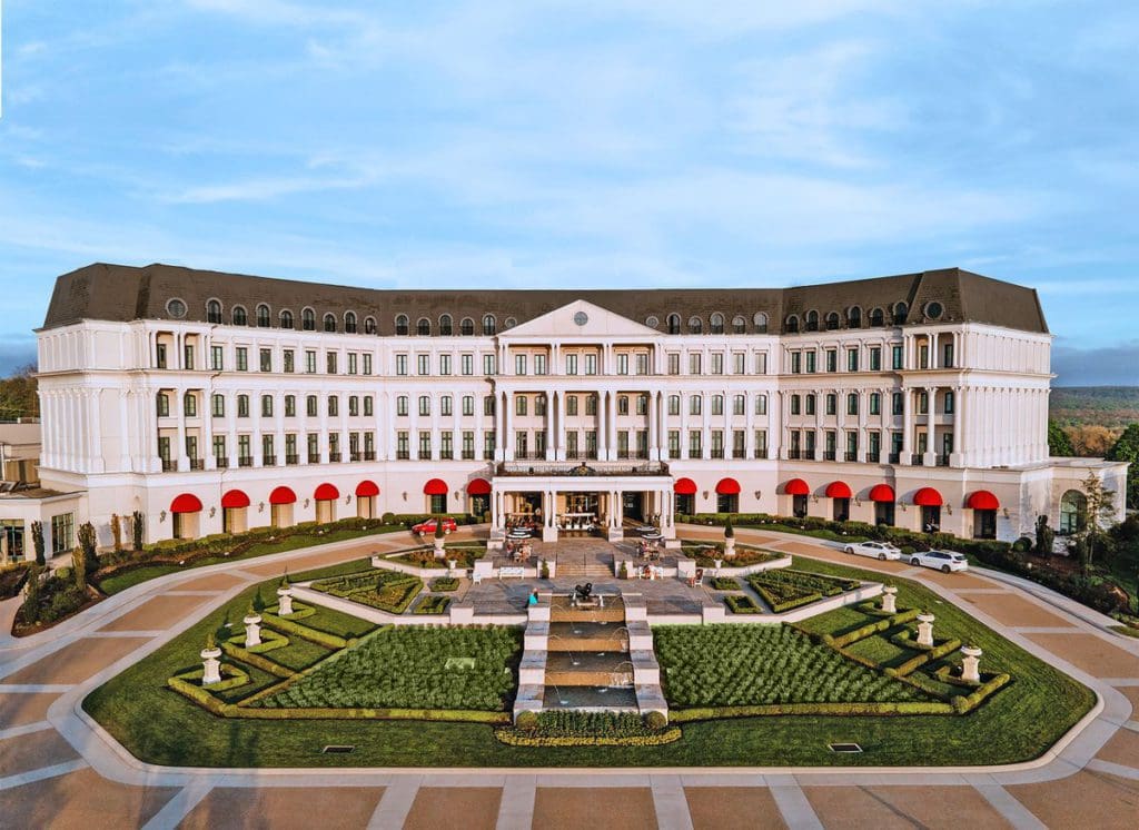 The large, stately Nemacolin Resort on a sunny day, a family resort in Pennsylvania your family will love.