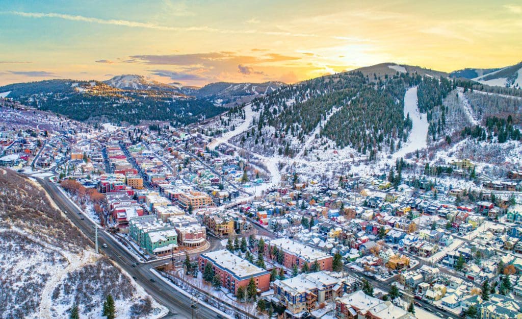 An aerial view of Park City, featuring a lovely town and ski runs during the winter.