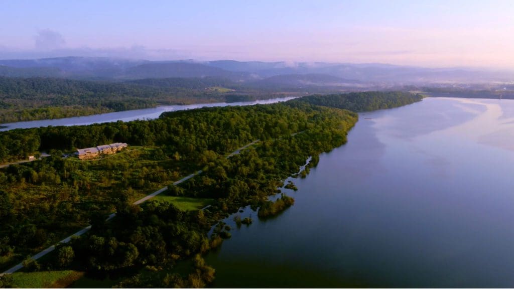 An aerial view of The Nature Inn at Bald Eagle and the surround area along the lake at one of the best eco-friendly hotels in the United States for families.