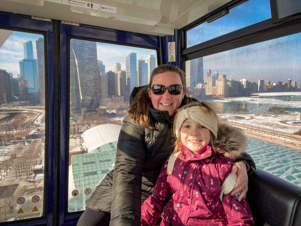 A young girl and her mom ride in the Centennial Wheel together, while visiting Chicago.