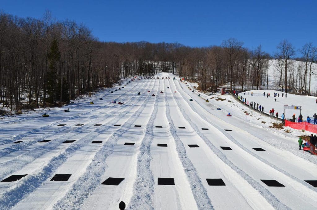 Several runs of snow tubing with riders racing down the tracks at Campgaw Mountain Ski Area.