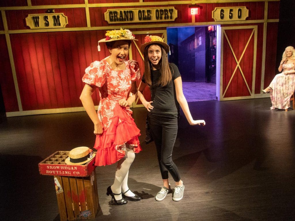 A teen girl poses with Minnie Pearl at Madame Tussauds Nashville.