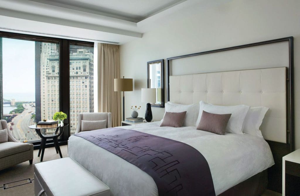 A Deluxe King room at The Langham, Chicago, featuring a king bed, large window, and spacious guest-room experience.