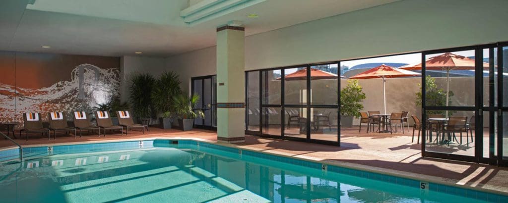 The indoor pool at the Renaissance Nashville Hotel, one of the best Nashville hotels for families, with sliding door open to the outdoor patio.