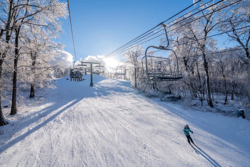 A ski run with one lone skier at Wisp Resort, above the skier is the chair lift.