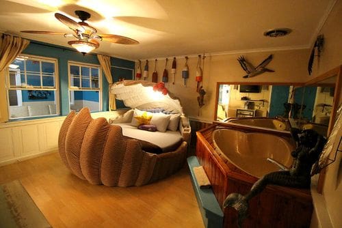 Inside the Deserted Island themed room, featuring an oyster bed, bouys hanging on the wall, and other island-themed furnishings.