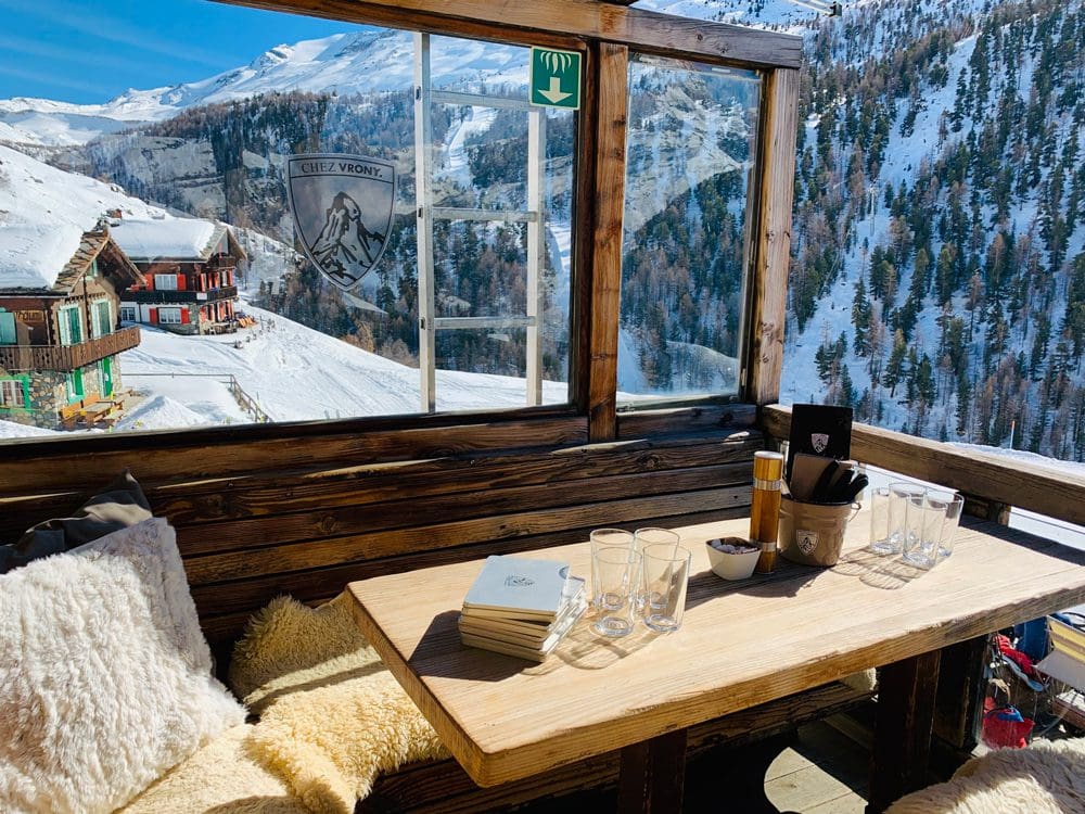 A cozy table setting at Chez Vrony, one of the best on-mountain restaurants in Zermatt for families.