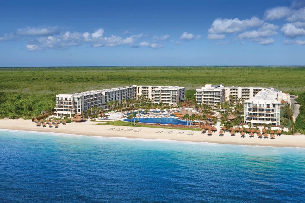 An aerial view of Dreams Riviera Cancun Resort & Spa, featuring its beachfront location, ocean views, and tropical location.