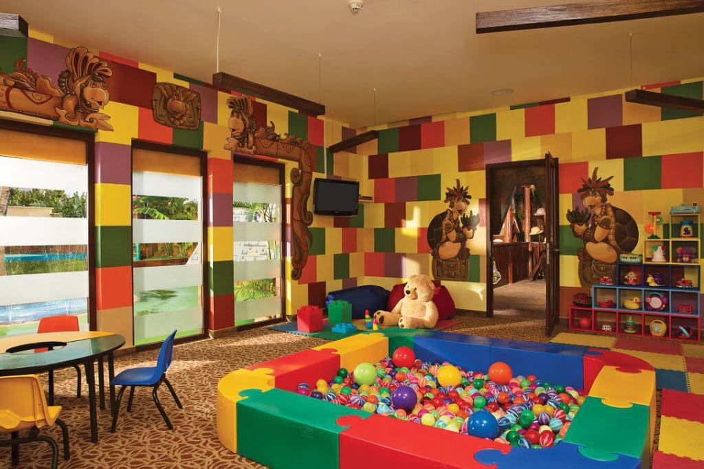 Inside the colorful kids' play area at Dreams Riviera Cancun Resort & Spa, featuring a small table and ball pit.