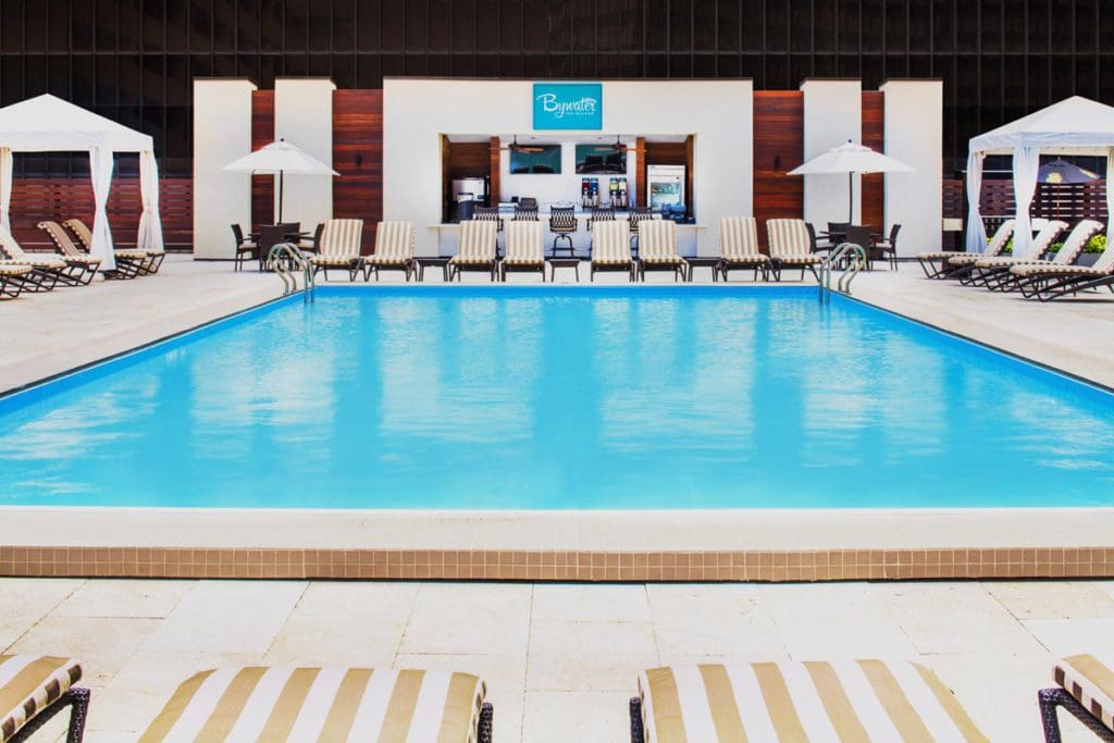 The pool at Hyatt Regency New Orleans, featuring a concessions area and several nearby poolside loungers.