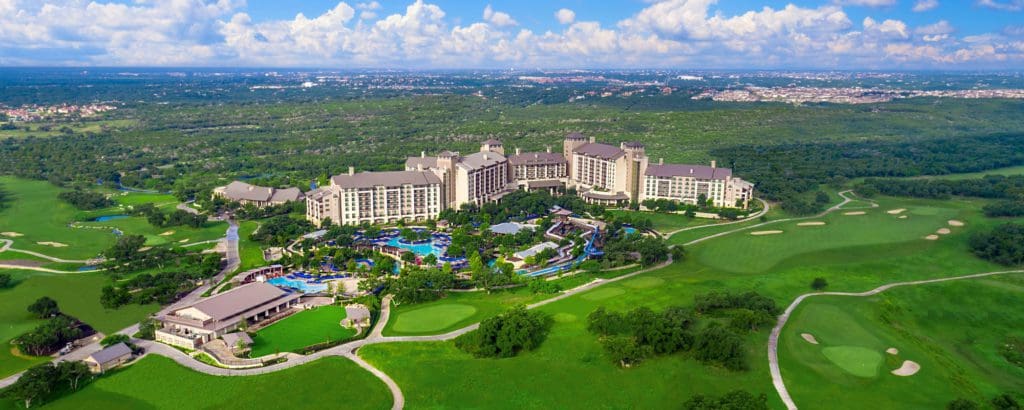 An aerial view of the lush green grounds and resort buildings at JW Marriott San Antonio Hill Country Resort & Spa.