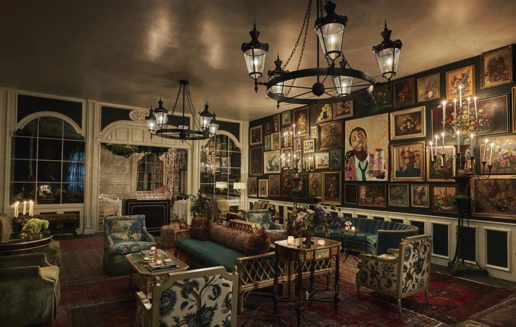 The lobby of the The Pontchartrain Hotel, featuring paintings of musicians and moody colors.