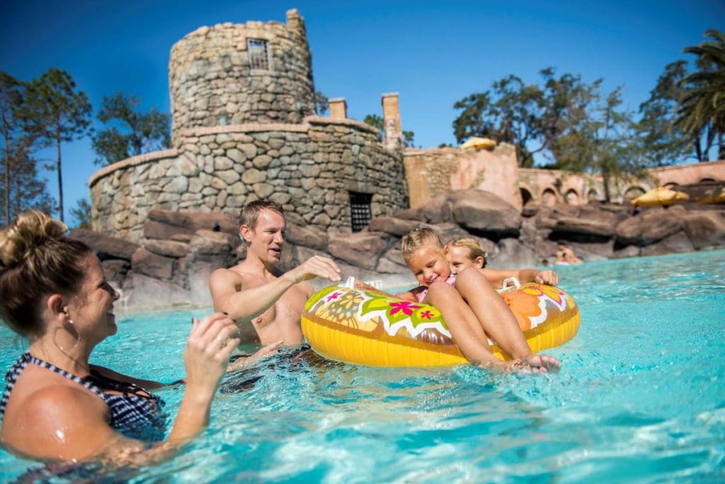 A family of three plays in the pool at Loews Portofino Bay Resort, one of the best resorts for families at Universal Orlando.