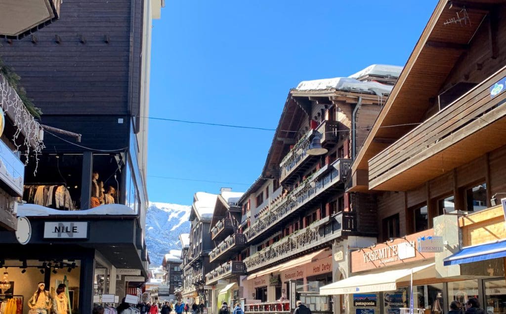 A view of the roofline along a charming street in Zermatt, featuring Swiss architecture. 