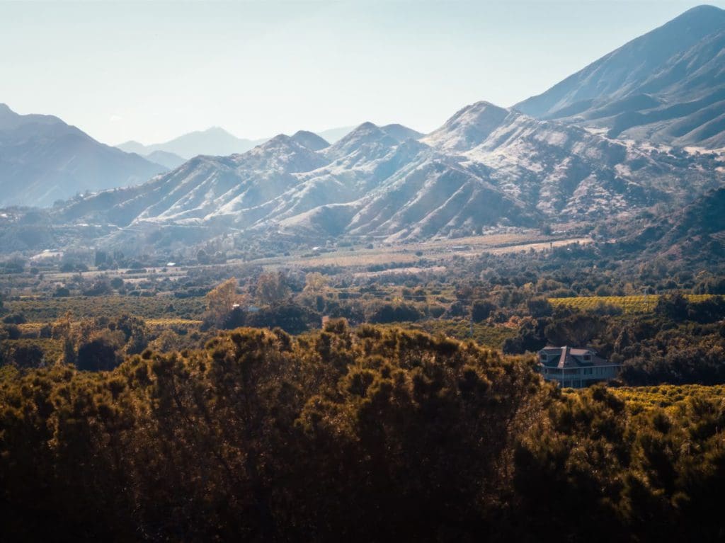 A sweeping view of Ojai, California, with a view of beautiful scenery and the mountains.