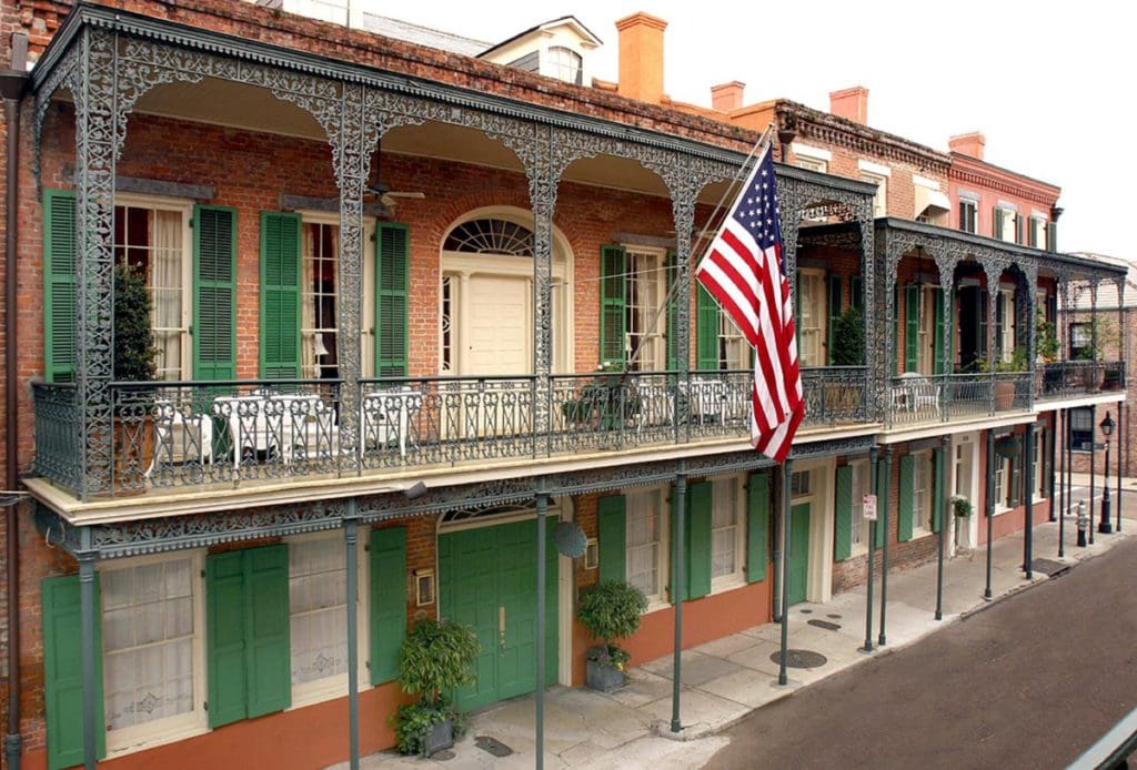 The exterior of the Soniat House Hotel, featuring southern-style wrought iron balconies at one of the best hotels in New Orleans for families.