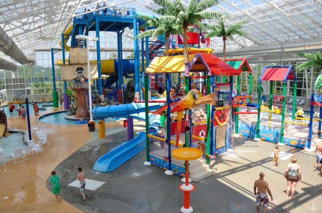 Inside the indoor water park at Big Splash Adventure, featuring colorful slides, a splash zone, and several play areas.