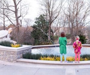 Two kids admire a fountain at Visit the Cheekwood Estate and Gardens.