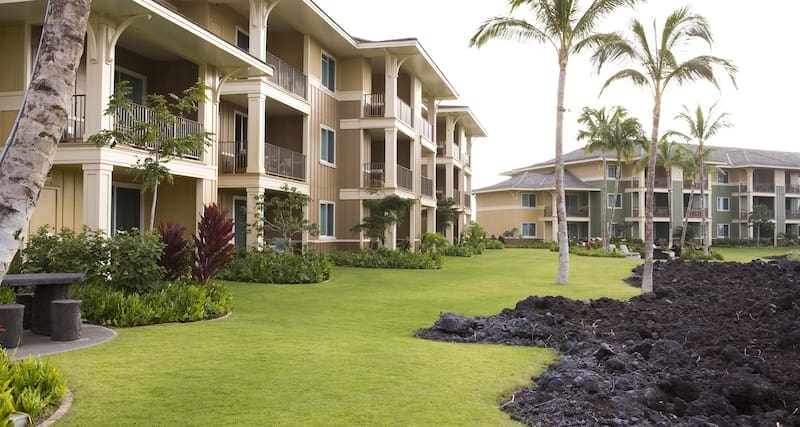 Resort building extend along a green, grassy area at Hilton Grand Vacations Club Kings’ Land Waikoloa.