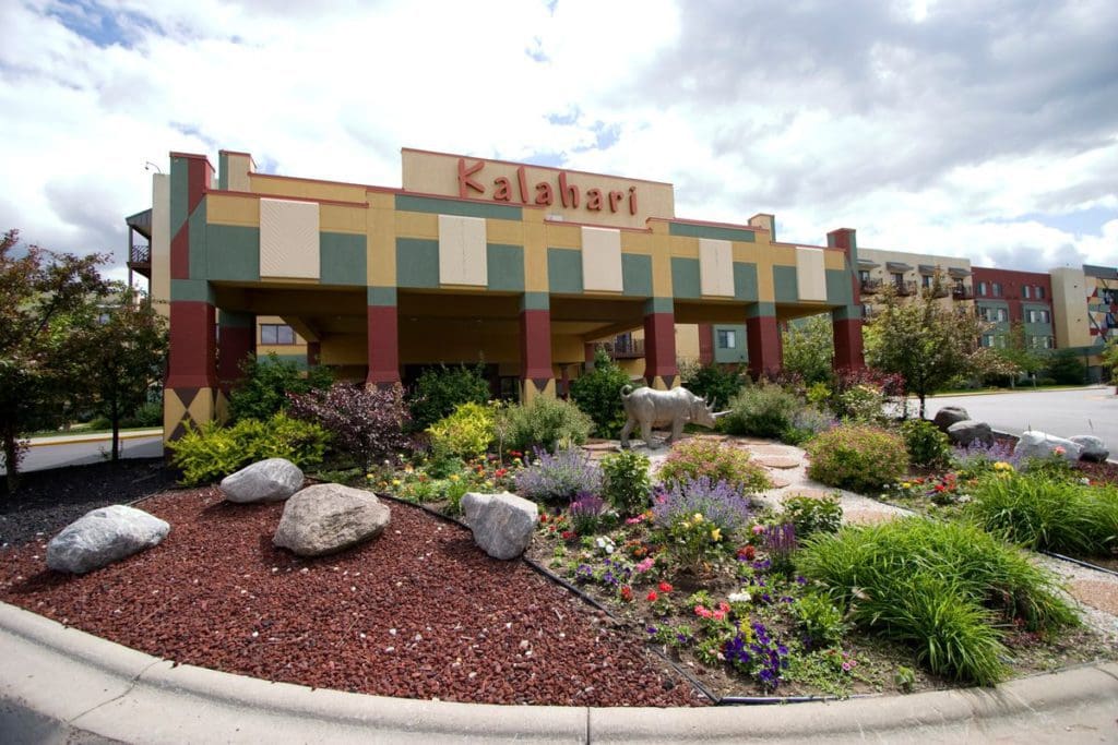 The exterior entrance to Kalahari Resort in the Wisconsin Dells, featuring a large garden area out front.