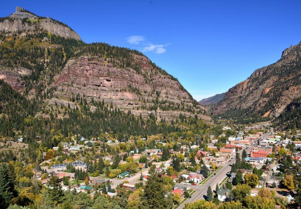 An aerial view of the Ouray downtown area, with a view of the mountains in the distance.