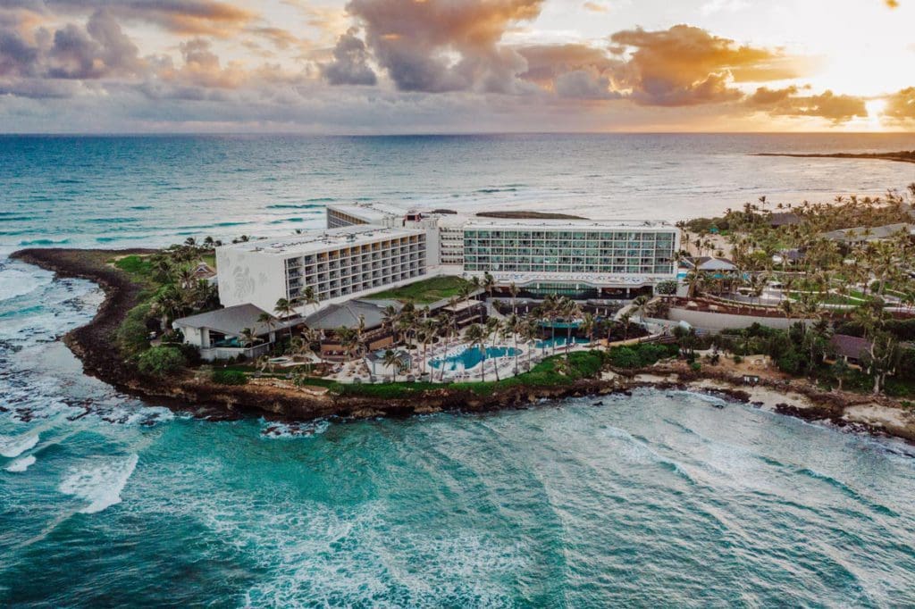 An aerial view of Turtle Bay, located on a peninsula surrounded by water, one of the best resorts for families in O'ahu.