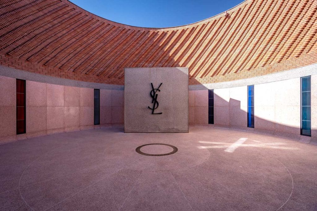 Inside the YSL Museum, featuring a large open-air space with many doors and the letters Y S L on the far wall.