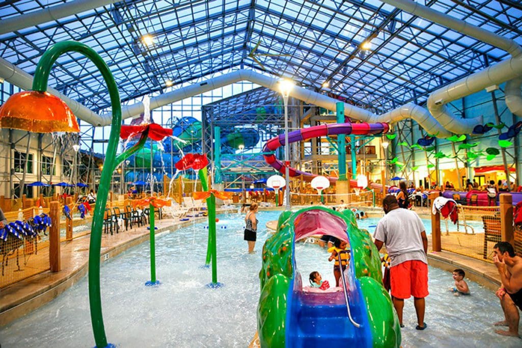Inside the indoor water park at Zehnder’s Splash Village Hotel and Water Park, featuring colorful slides and splash zones.