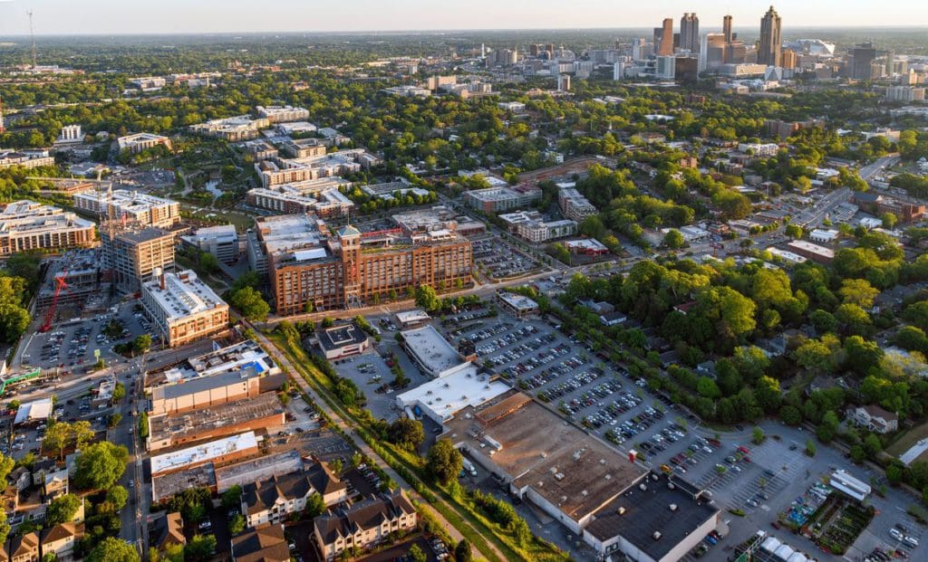 An aerial view of Ponce City Market, along the Beltline, with the Atlanta skyline in the distance.