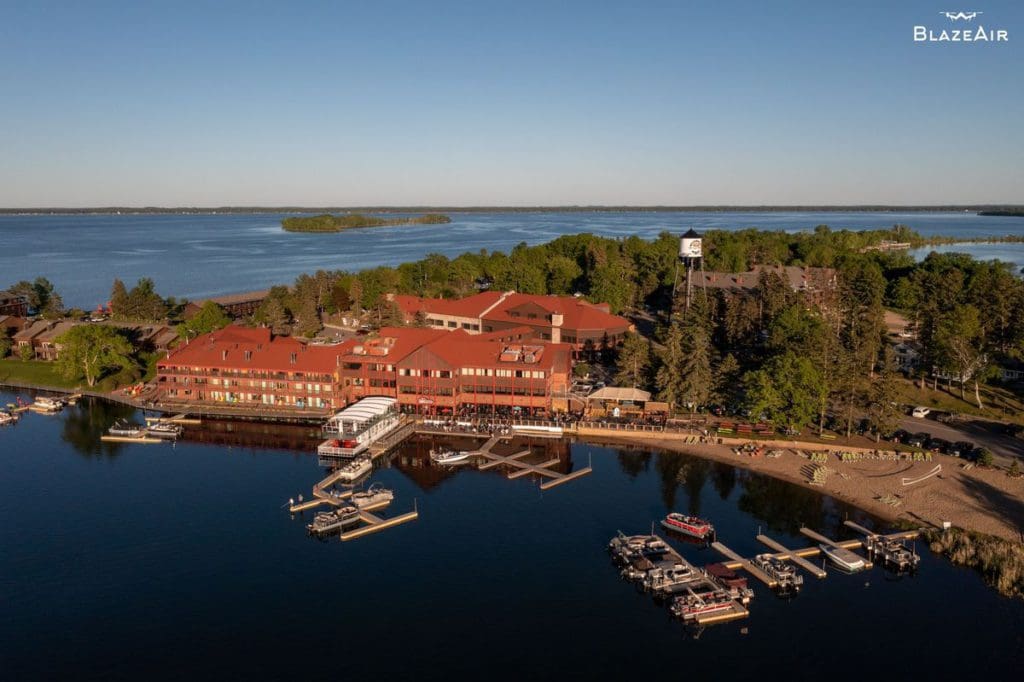 An aerial view of Breezy Point Resort, featuring its lakeside location, many docks, and resort buildings.