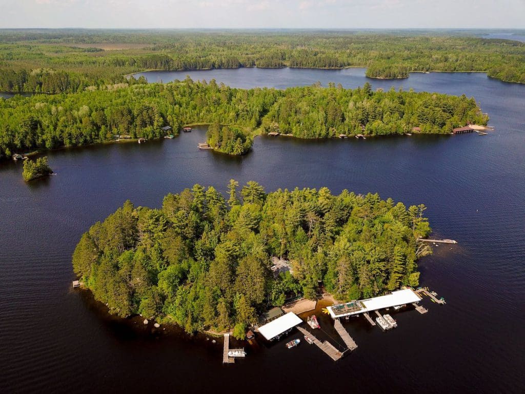 An arial view of Ludlow’s Island Resort, a heavily wooded island on a beautiful lake and one of the best places to visit northern Minnesota with kids.