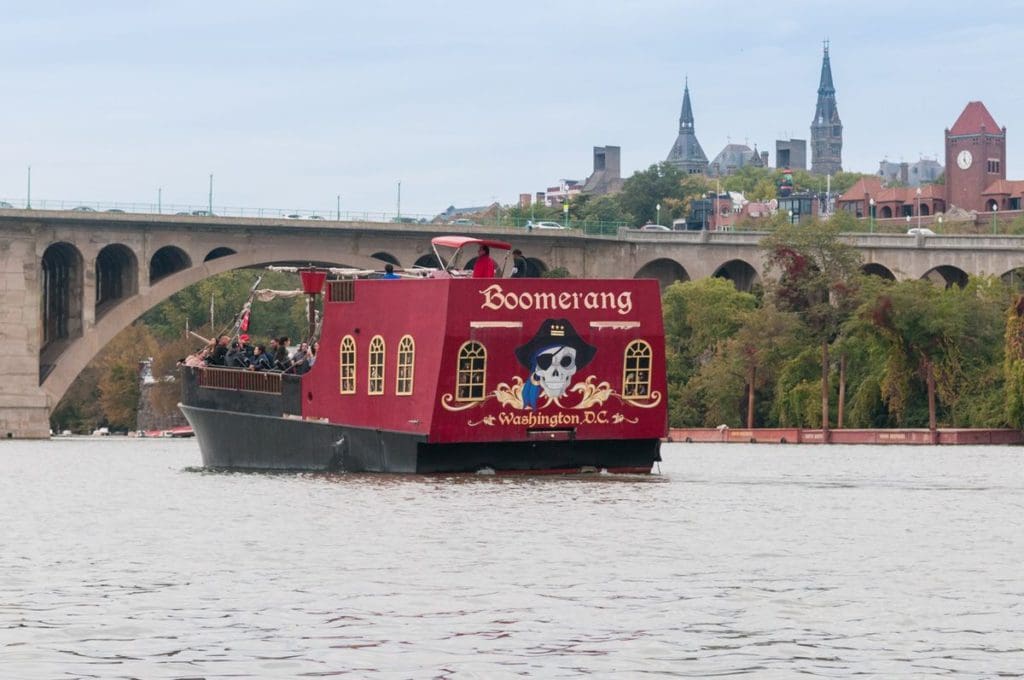 The Boomerang Pirate Ship, with black and red coloring, moving down the Potomac River.