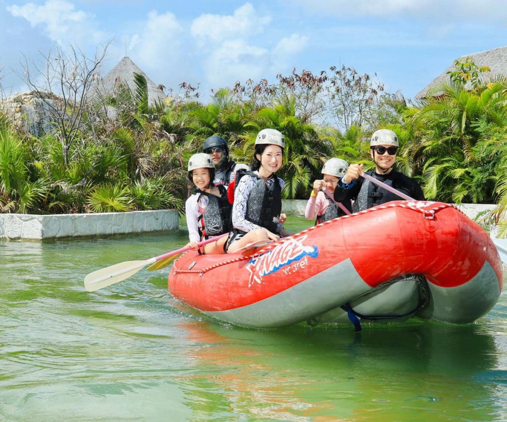 A family rides along a raft while exploring Playa del Carmen together.