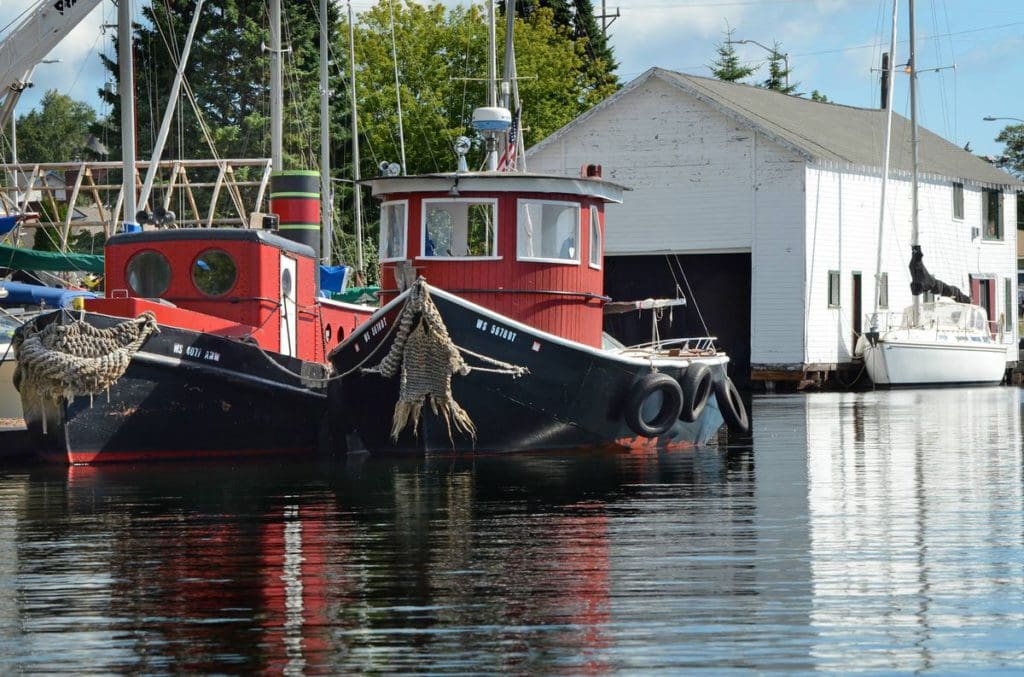 Two boats rest while docked in the water at the marina in Bayfield.