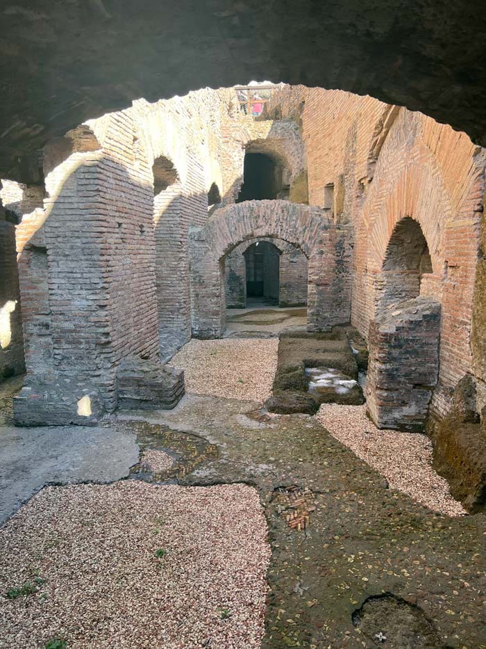 The Colosseum's underground corridors revealed, while on an underground tour, a must do on our Rome itinerary with kids.