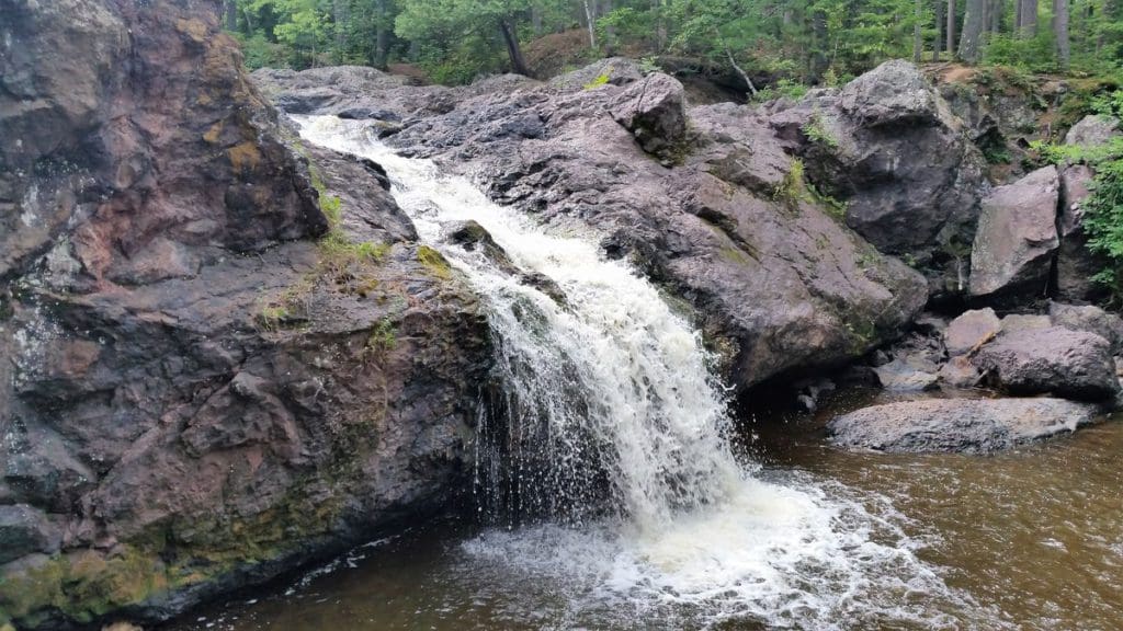 The flowing falls through rough rocks at Amnicon Falls State Park in Wisconsin.