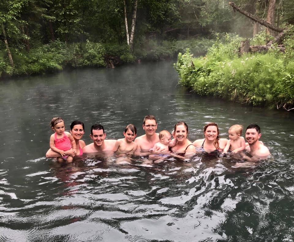 A multi-family group crowds together in the Liard Hot Springs Provincial Park in British Colombia.