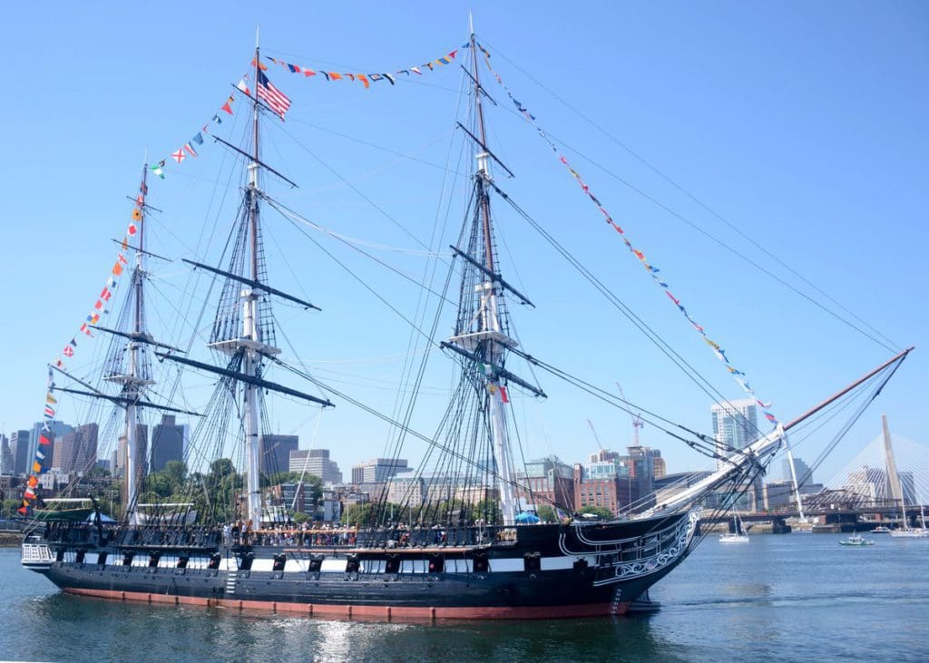 The USS Constitution proudly sailing through Boston Harbor.