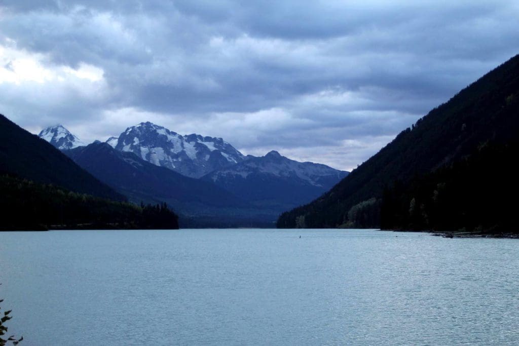 A stunning lake scene with mountains flanked around the lake along the Sea to Sky Highway in British Colombia, one of the best vacation destinations for families In Canada.