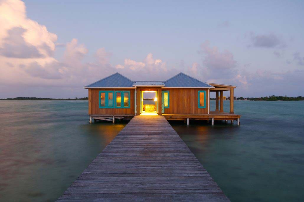 A boardwalk pier leads to a restaurant over the water at .Cayo Espanto Island Resort