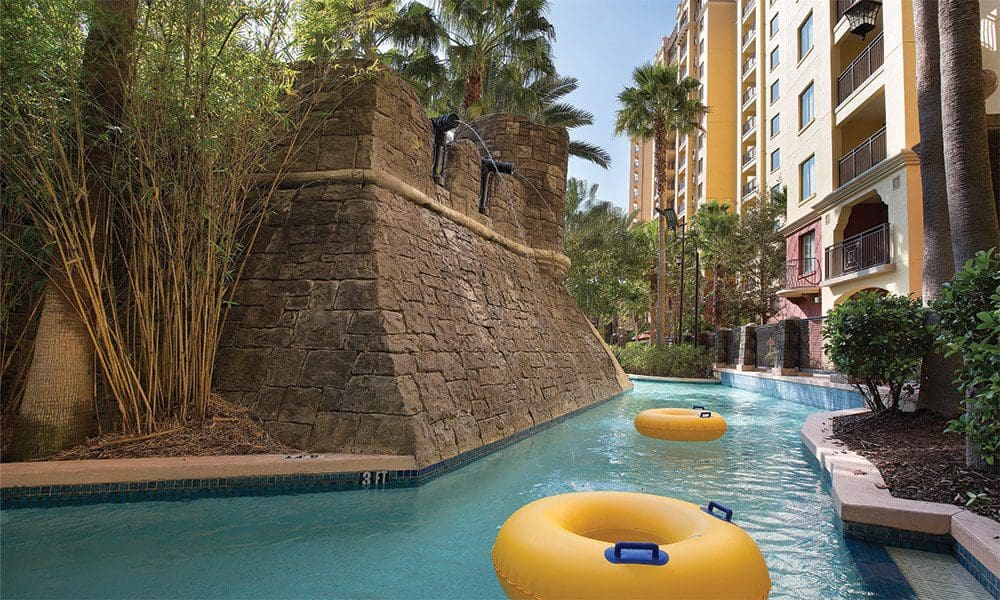 Large yellow inner-tubes float along a lazy river at Club Wyndham Bonnet Creek, one of the best hotels in Orlando with a waterpark for families.