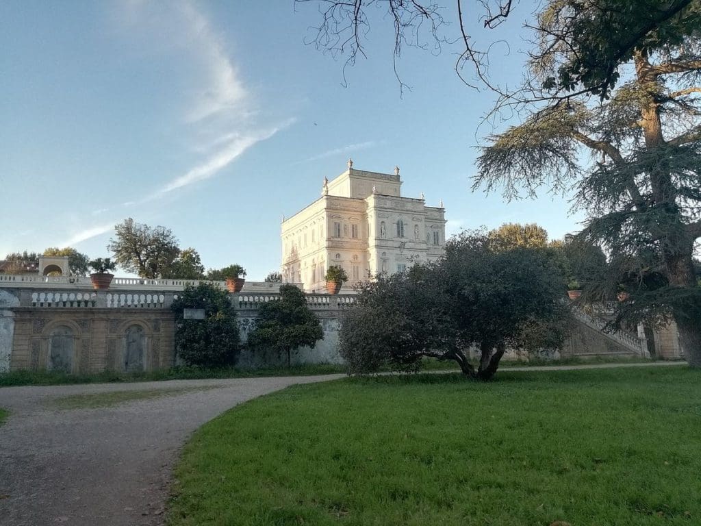 In the gardens of Villa Doria Pamphili, with the large white estate building in the distance.