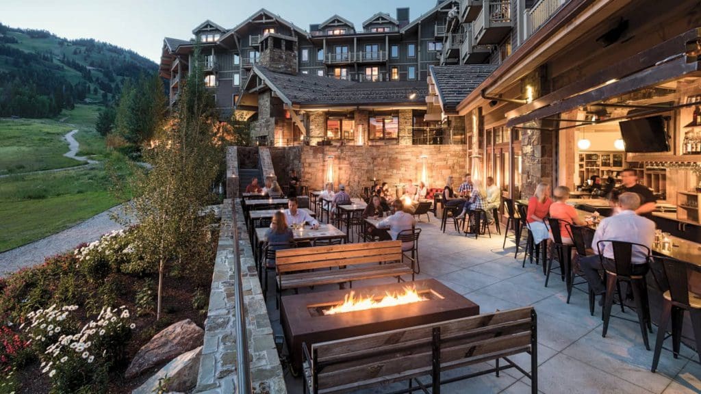 A photo of a cozy deck lined with fire pits at the Four Seasons Resort and Residences Jackson Hole.