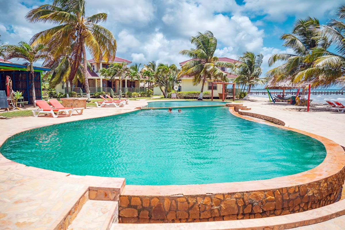 The intimate pool at Hopkins Bay Belize, a Muy’Ono Resort, with surrounding pool deck.